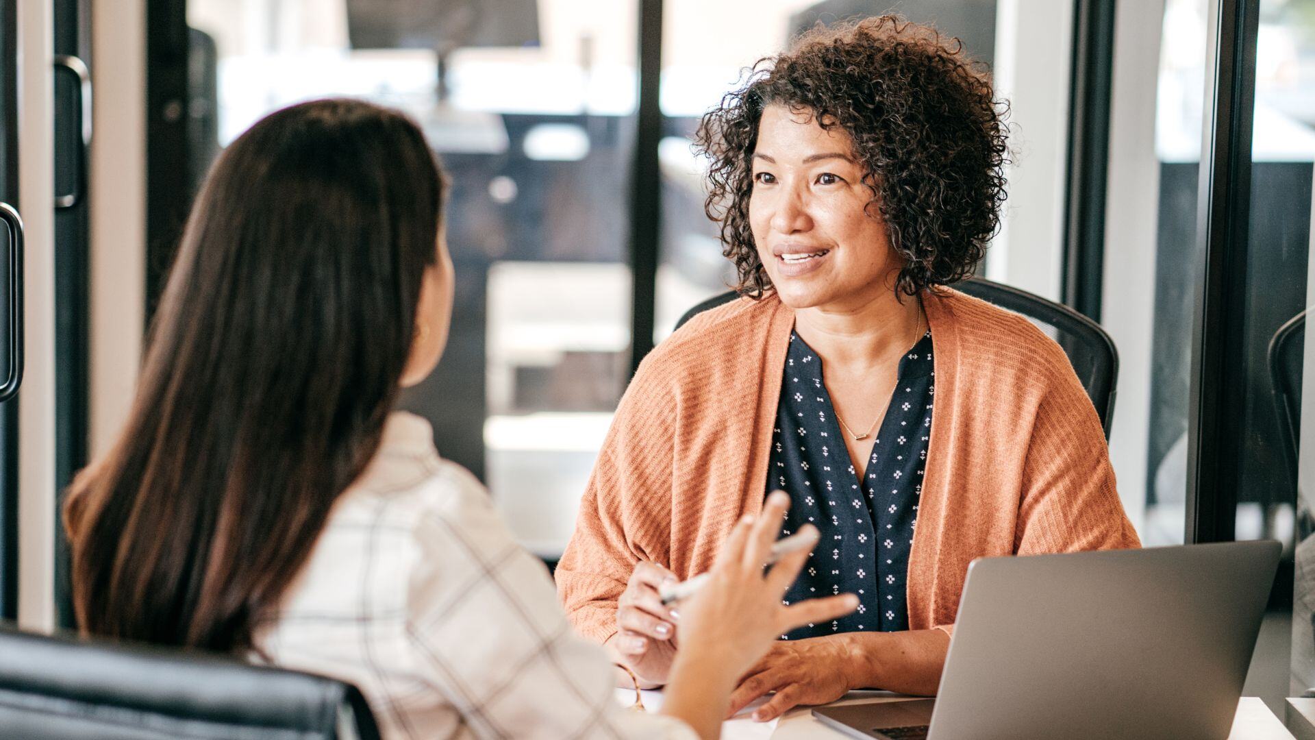 middle aged woman interviewing another woman