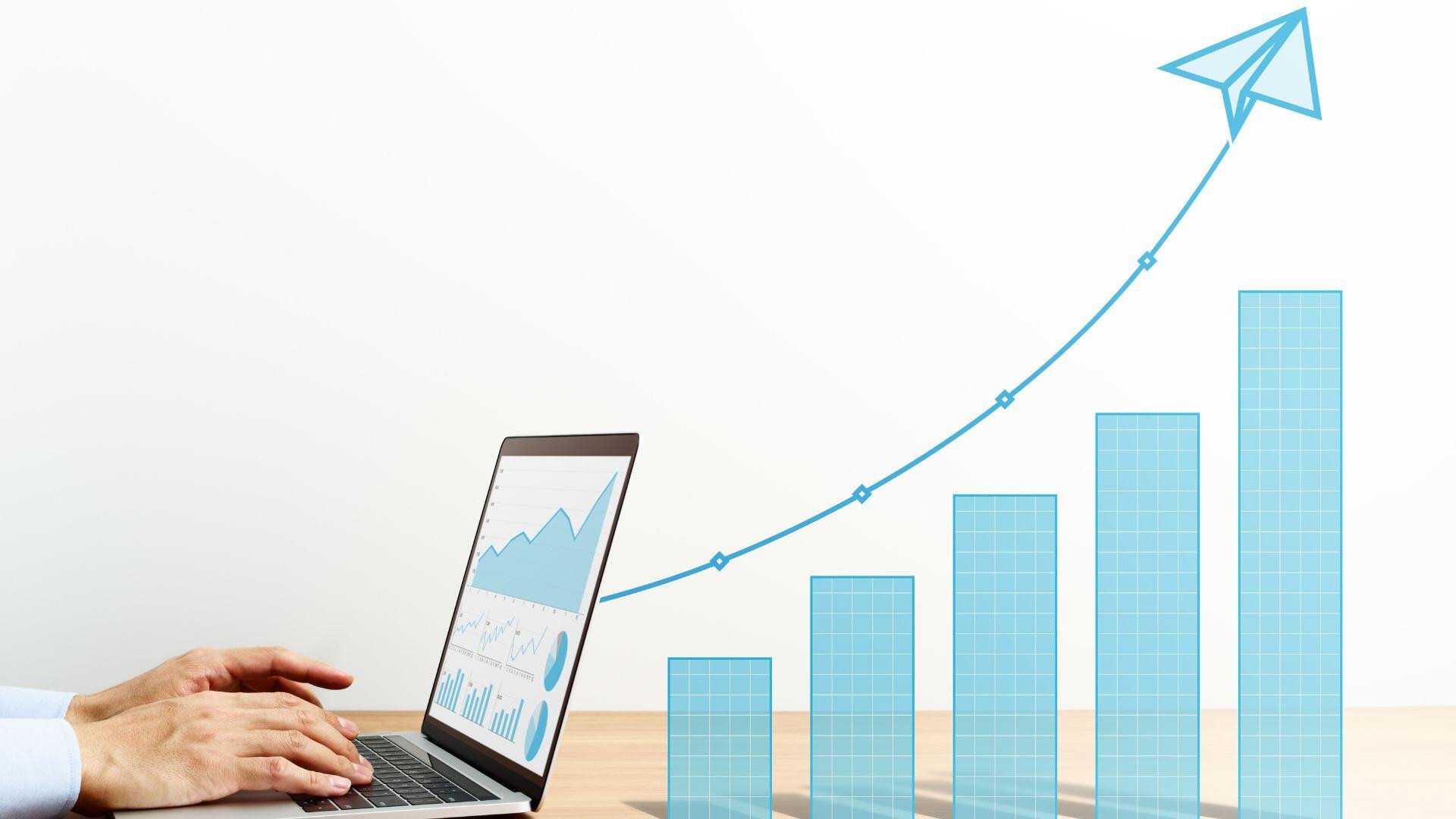 A computer with analytics on the screen followed behind by a bar chart showing growth