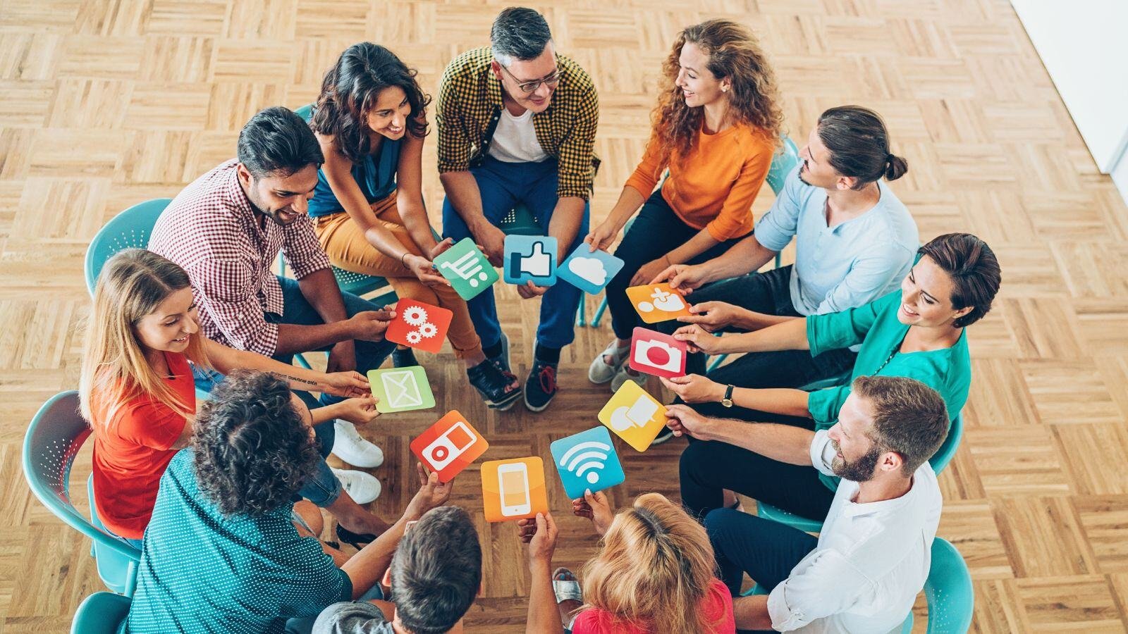 Image of people in a circle with arms extended holding social media engagement tool icons