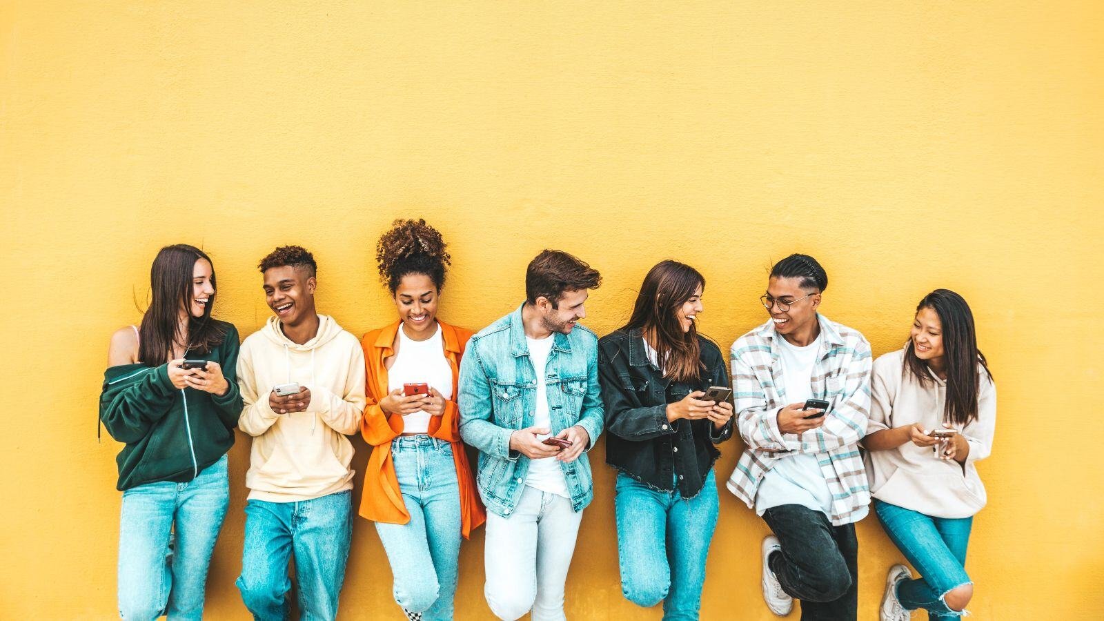 A group of young adults each on cell phones